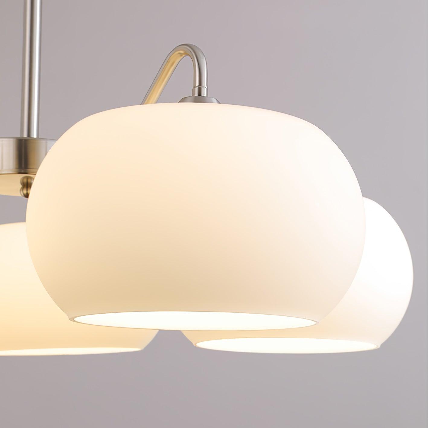 Persimmon chandelier with white glass shades and curved nickel-tone arms