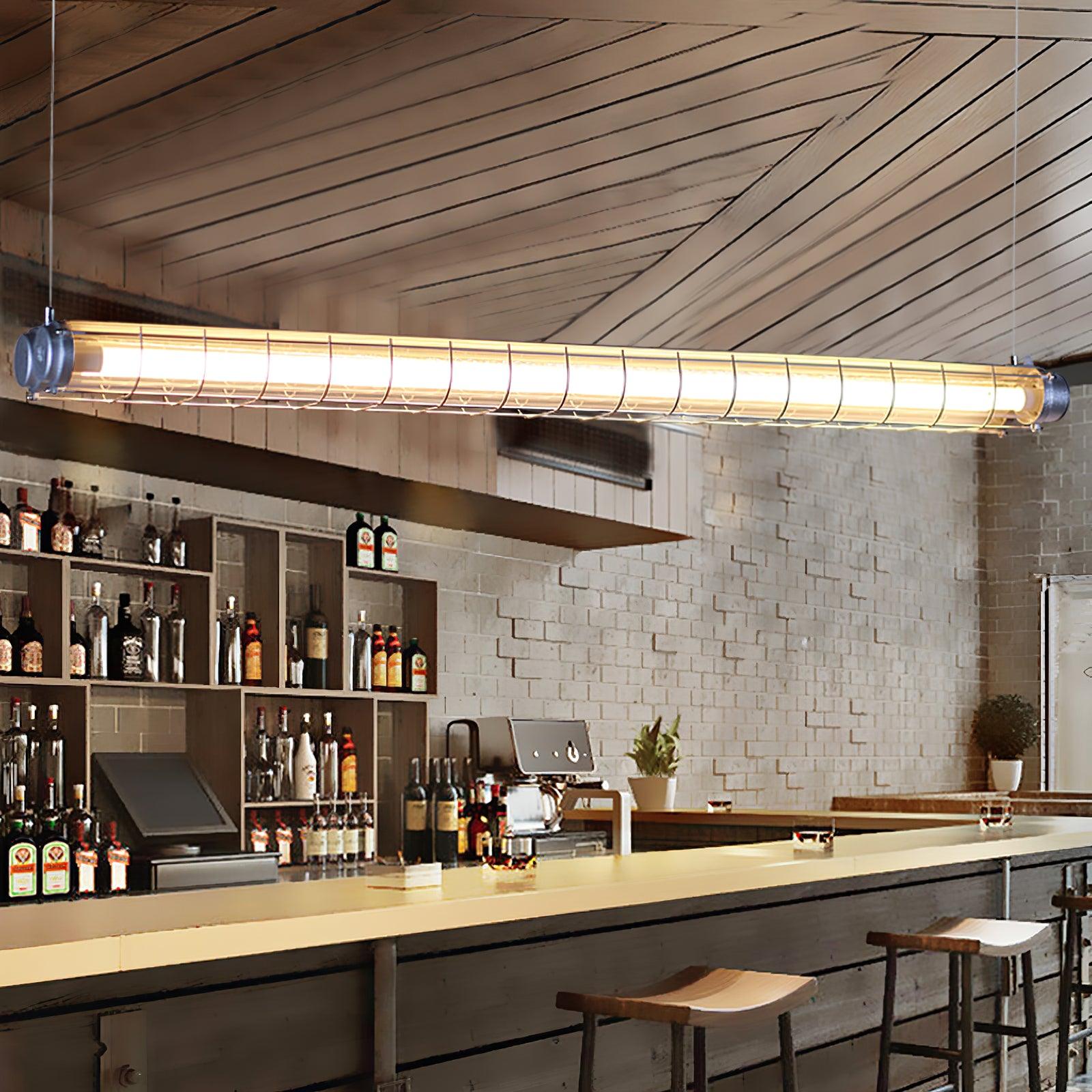Artisan Glass linear chandelier above a long cafe bar with bottle storage and stools