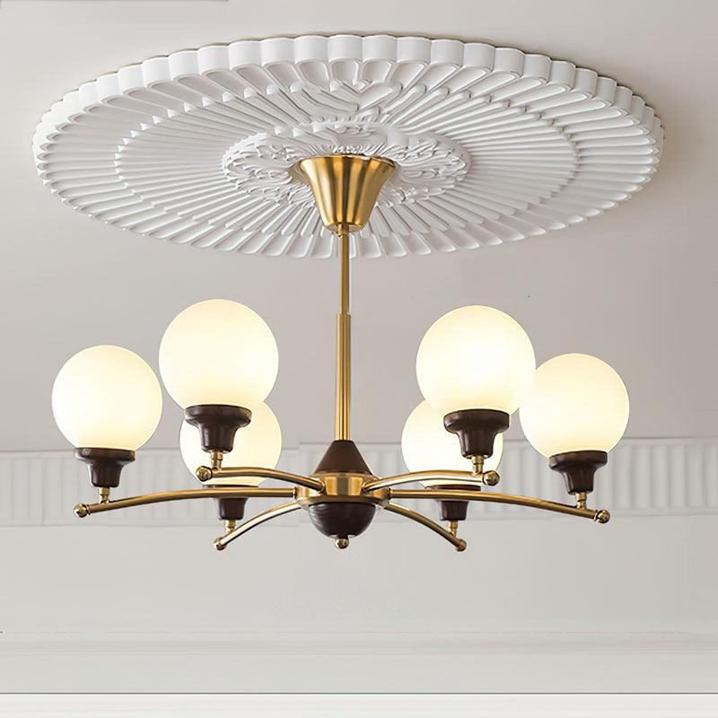 Six-light Gold option with white glass globes, walnut cups and gold rod beneath a decorative ceiling rose