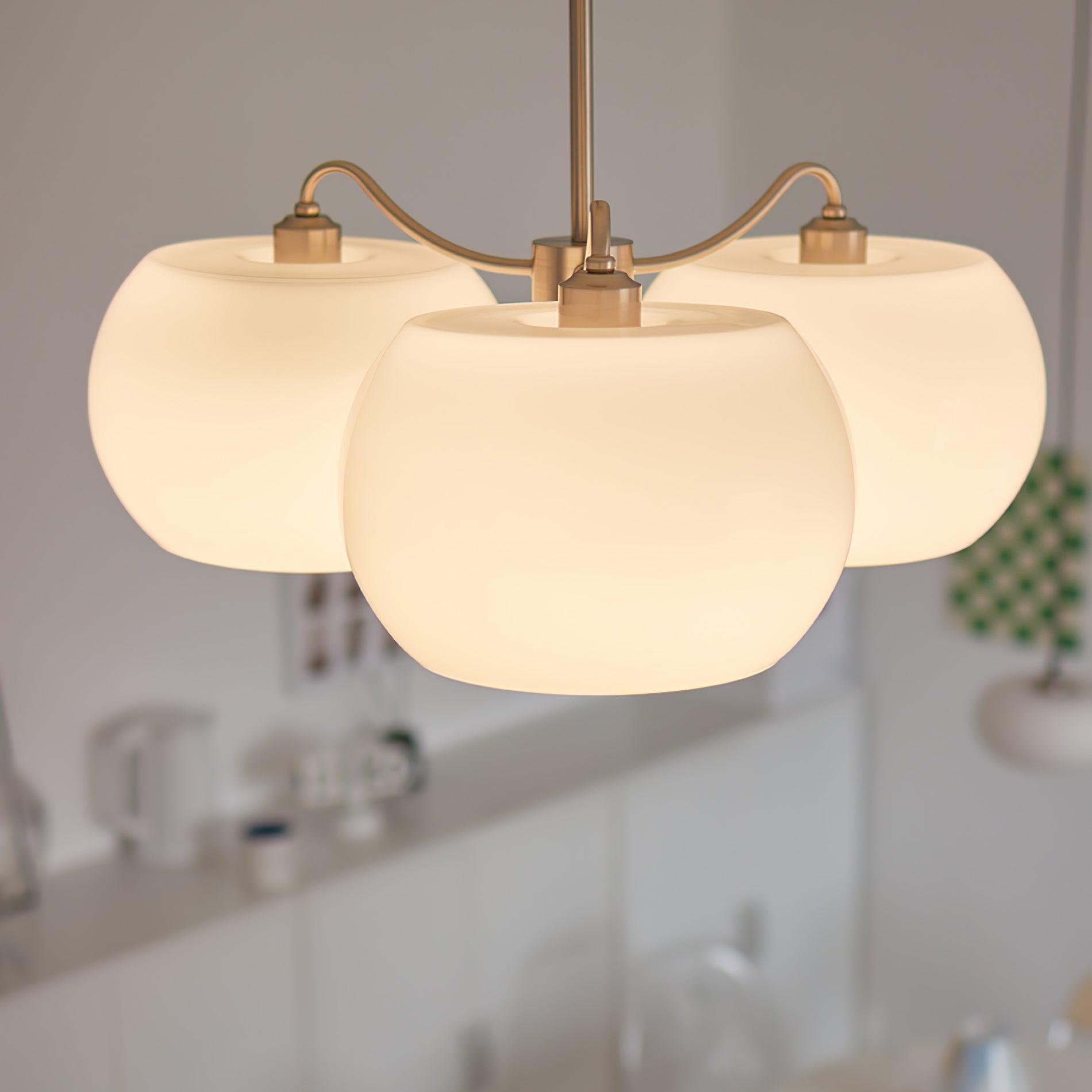Persimmon chandelier with white glass shades and curved nickel-tone arms
