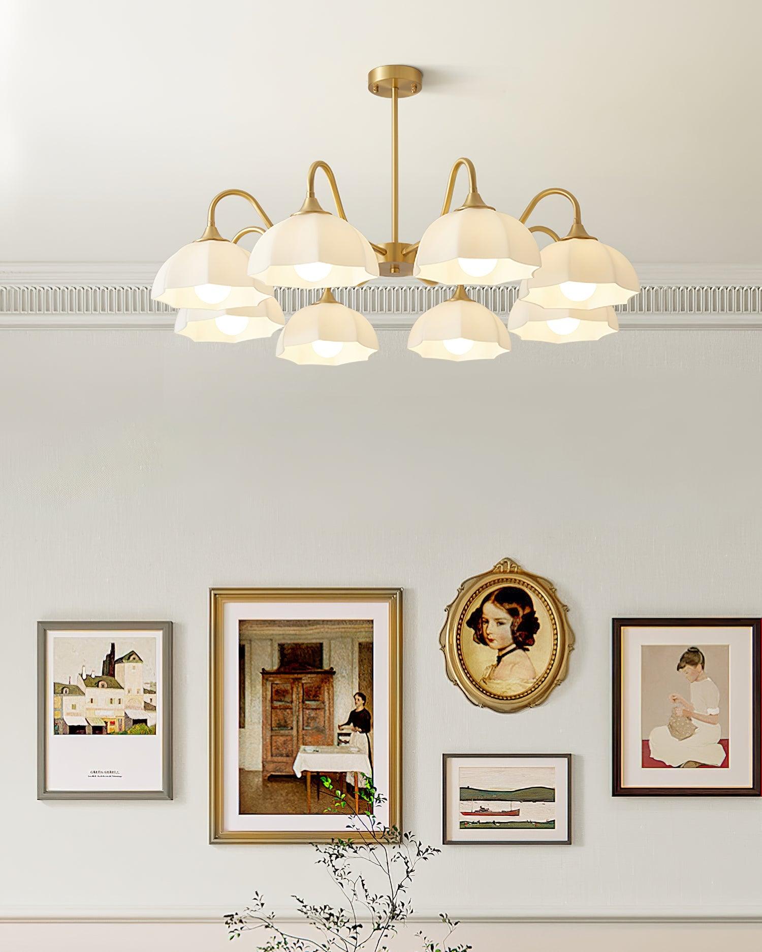 Wide white glass chandelier above wall pictures