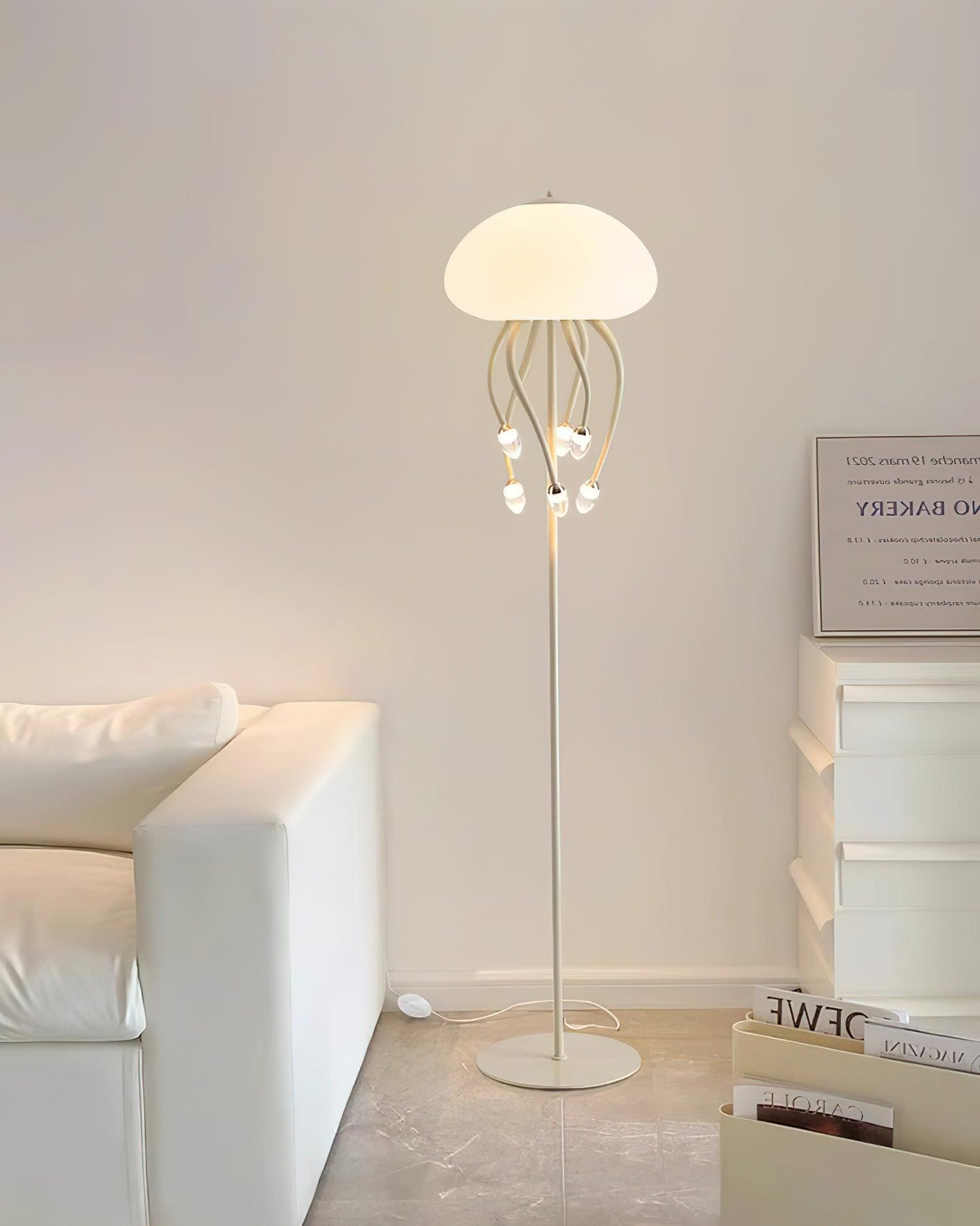 Beige six-arm Jellyfish floor lamp by pale sofa and white drawers, with cable and oval inline switch on tiled floor.