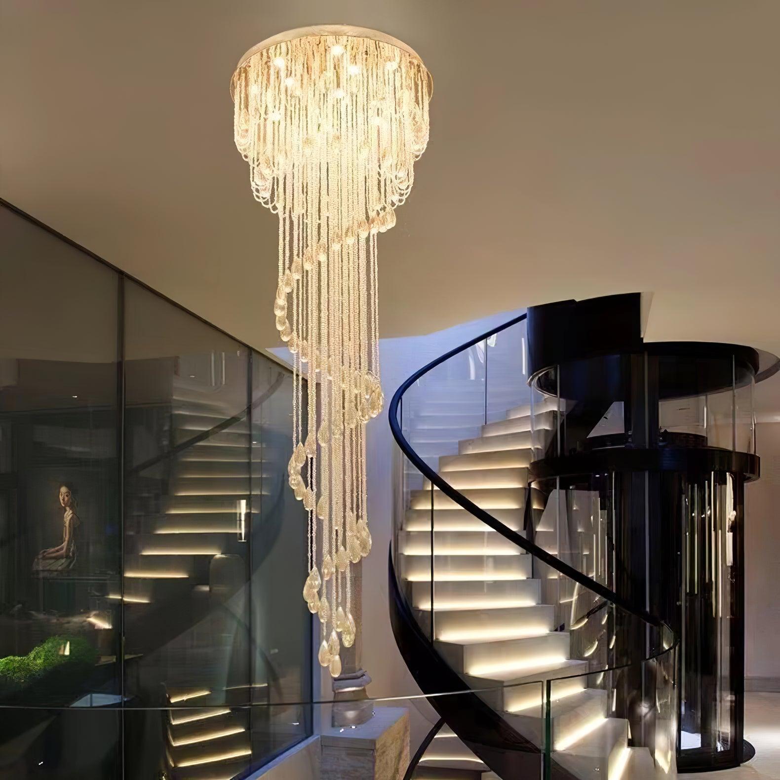 Warm-lit crystal spiral beside a modern curved staircase with glass balustrade, dark rail and mirrored reflections