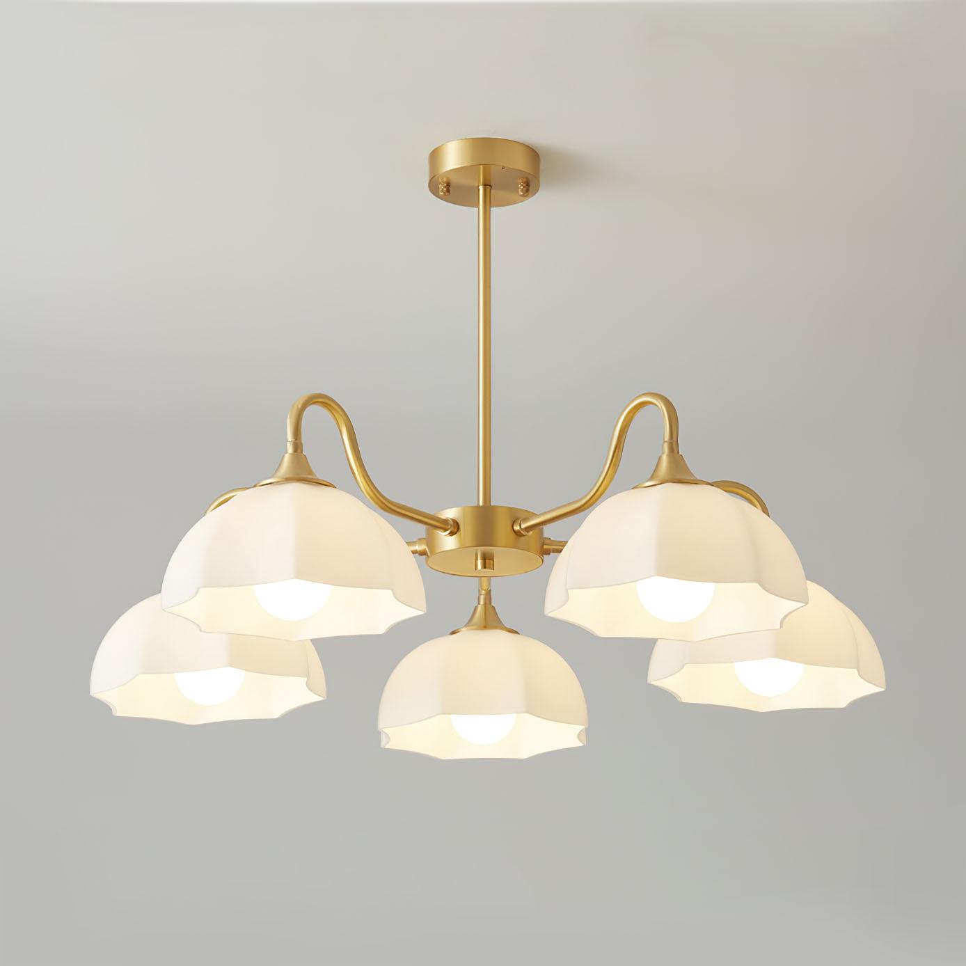 Five-head brass glass chandelier on pale background