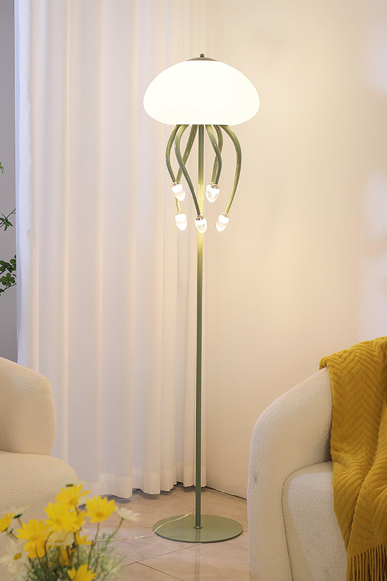 Green six-arm floor lamp between rounded pale chairs, with mustard throw, yellow flowers and white curtains.