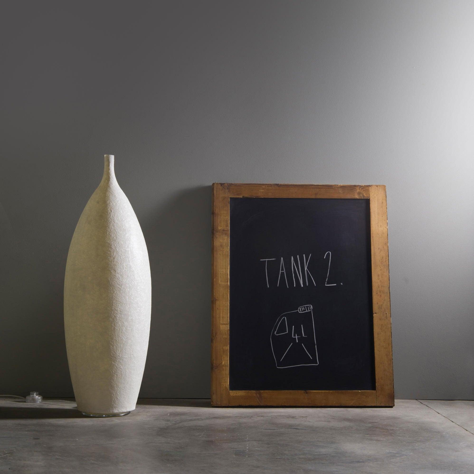 Closer view of short white textured light, inline cord control and wooden TANK 2 chalkboard