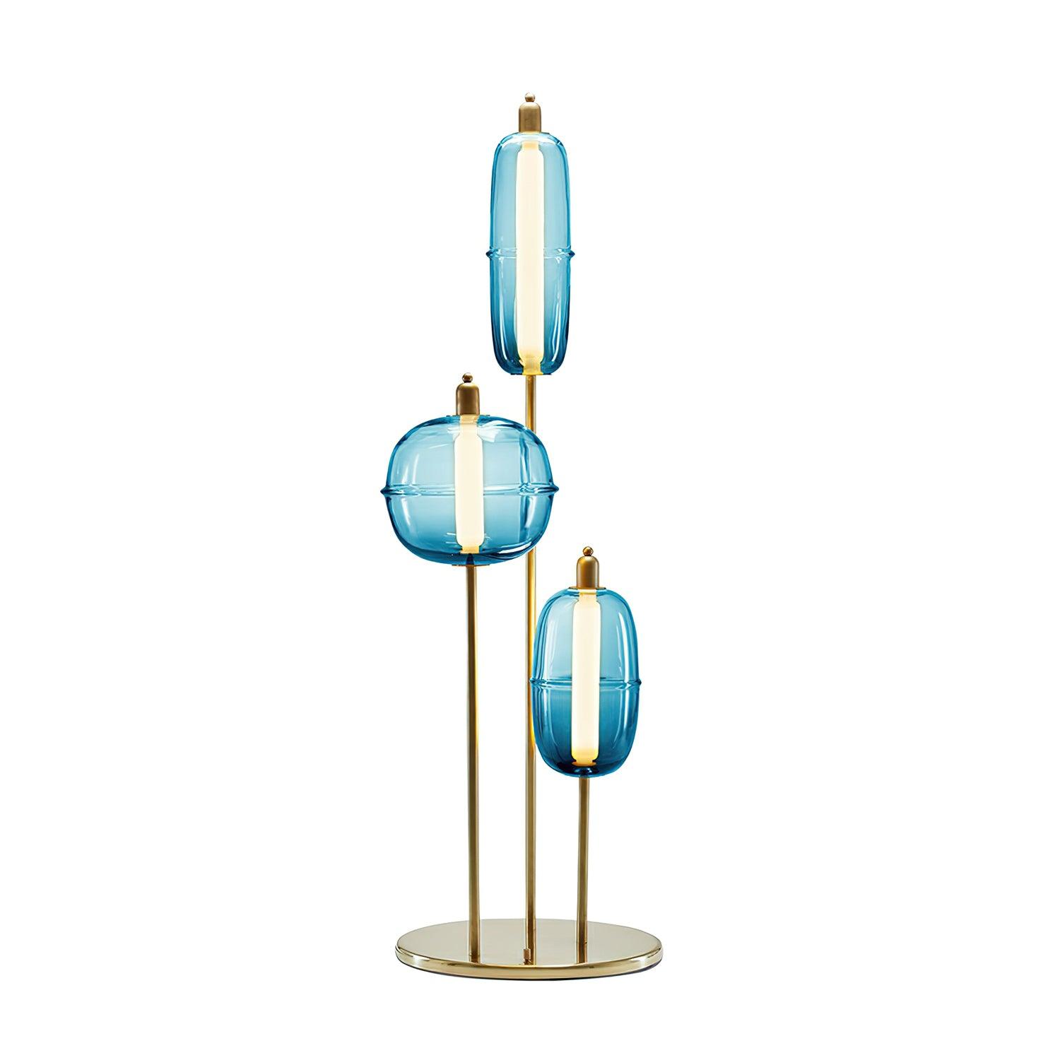 Gradient blue glass option with two capsule shades and one rounded shade on a gold stand with a circular base