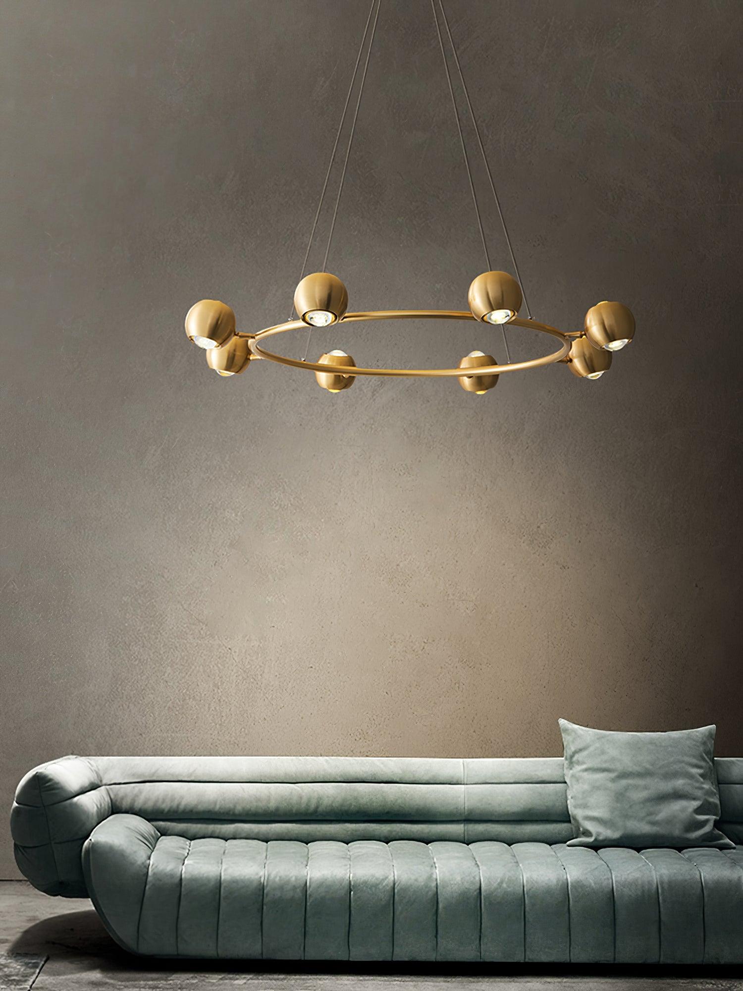 Six-head ring chandelier above a green sofa