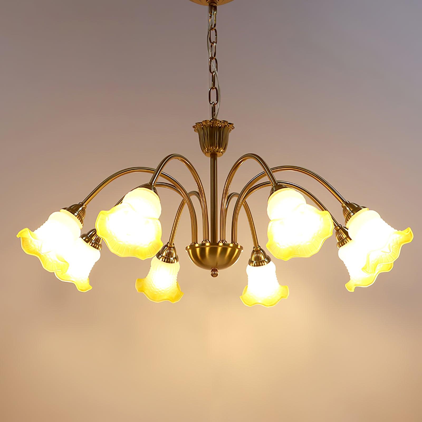 Yellow glass flower shades glowing beneath curved arms