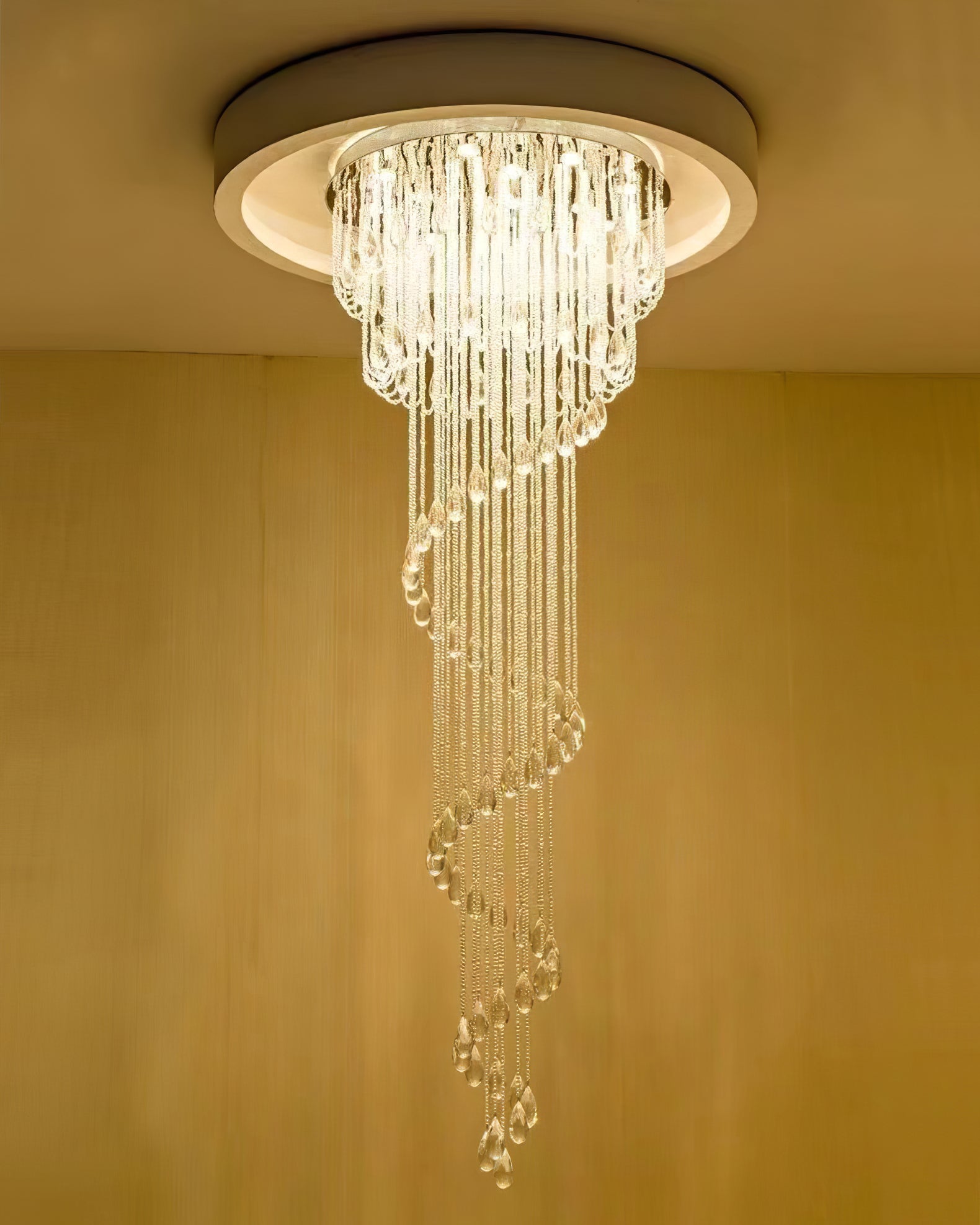 Lower-angle view of bright crystal spiral within a circular ceiling recess, with warm surrounding light