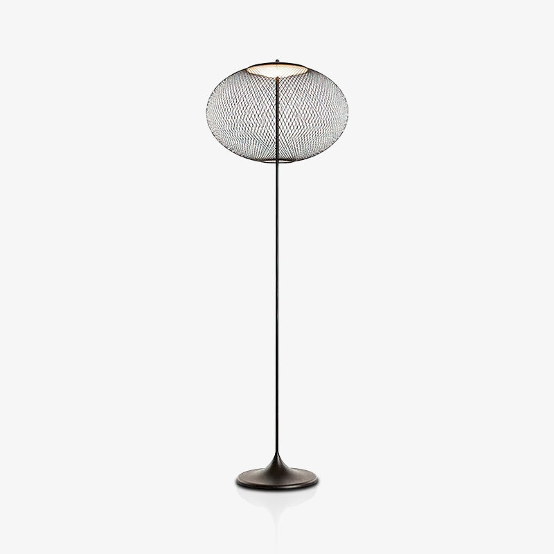 Full black mesh floor lamp on a pale background, showing its slender stem, round flared base and faint reflection below