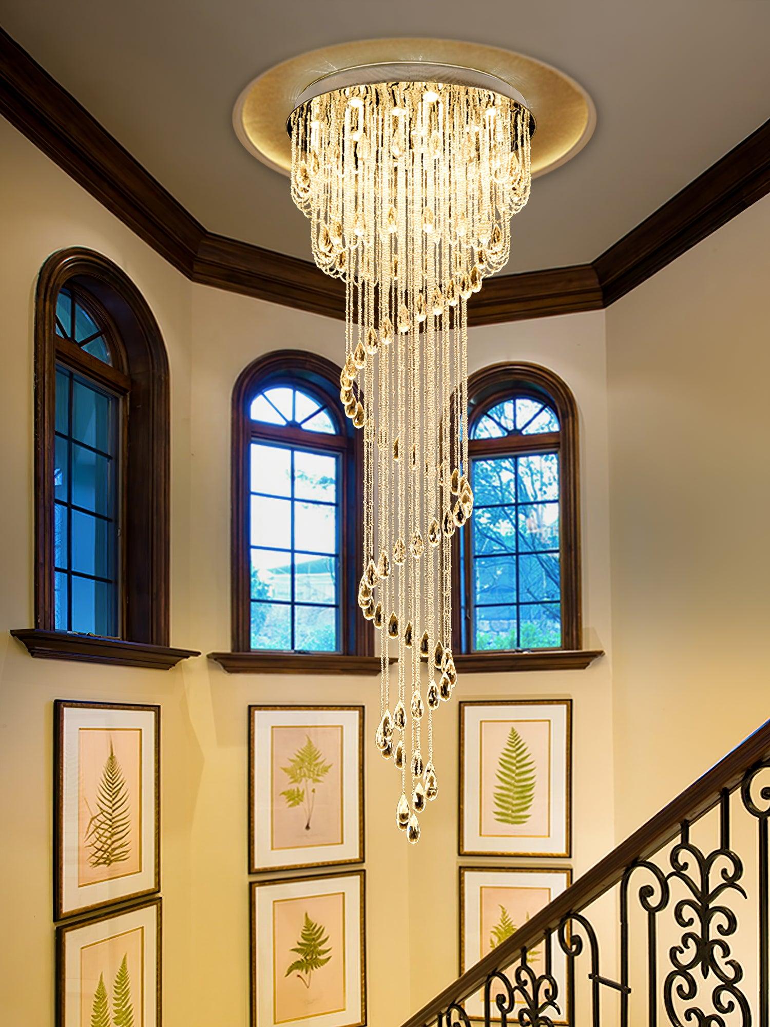 Crystal spiral by an ornate black stair rail, arched wood-framed windows and framed botanical fern prints