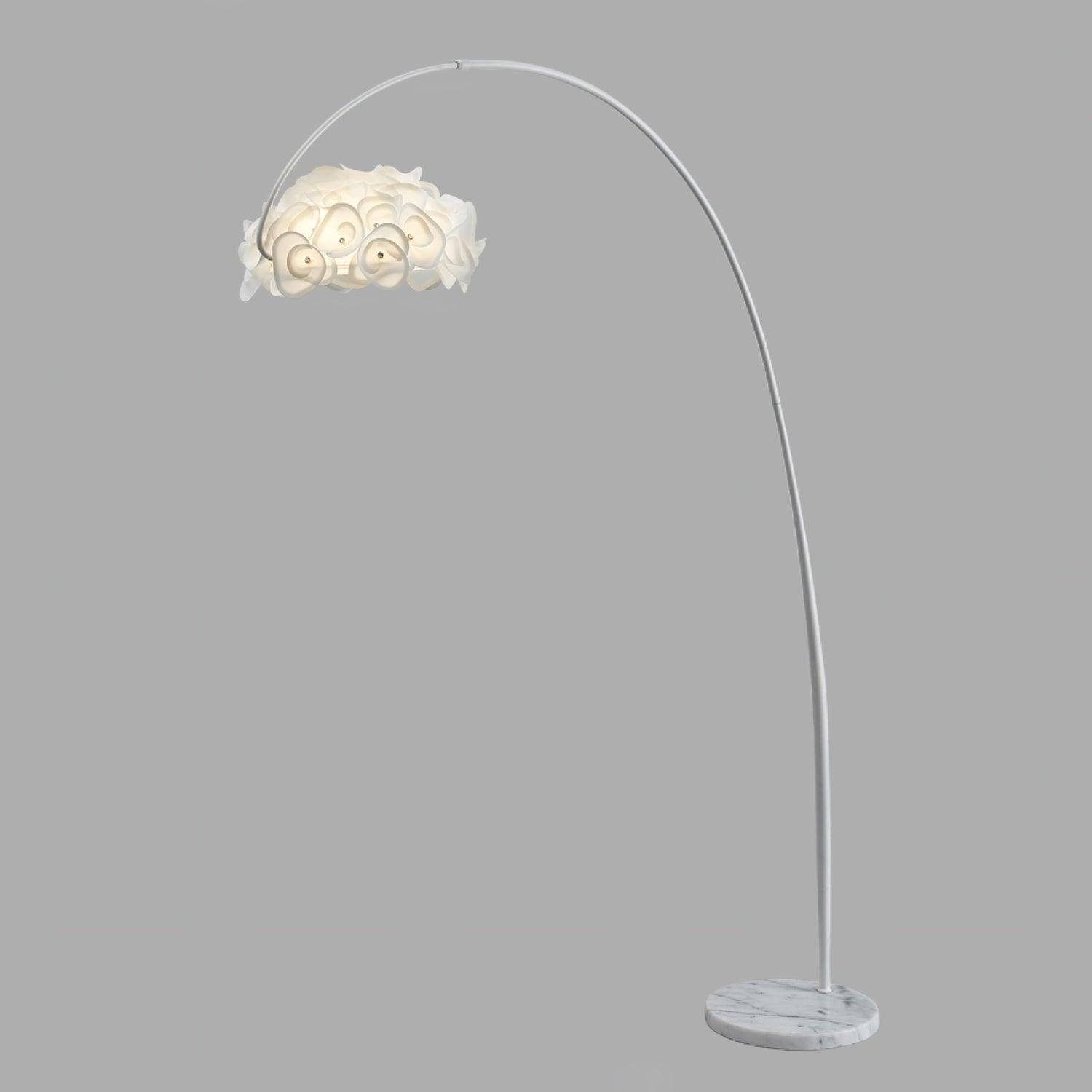 Small isolated arched white petal floor lamp on gray background, curved pole and gray-veined round base