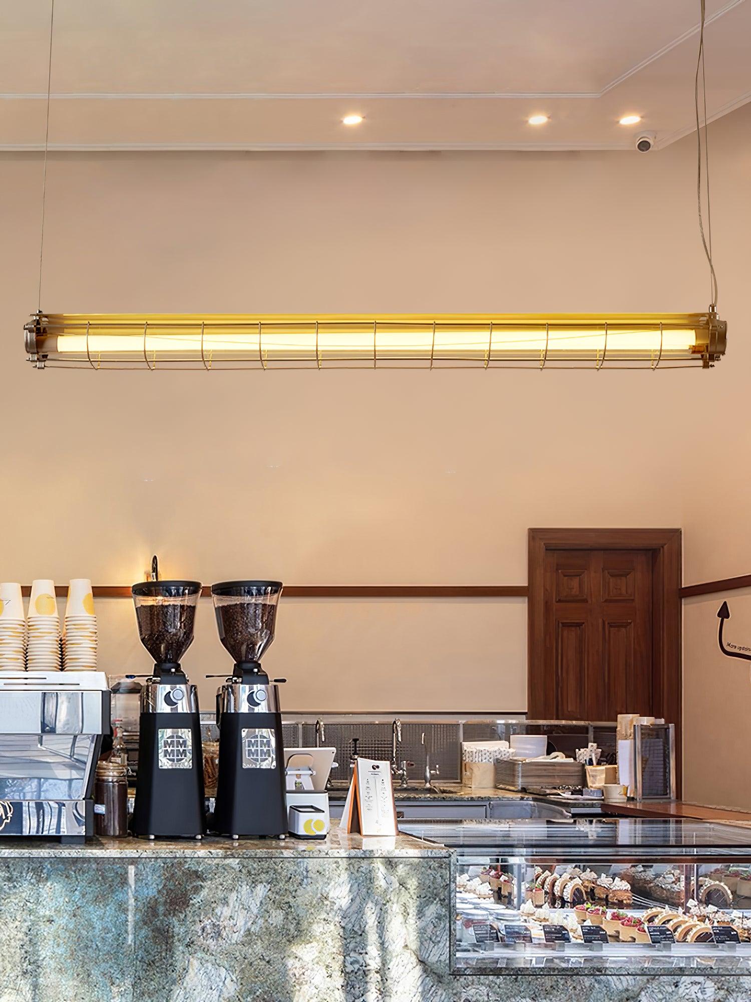 Artisan Glass lighting above a cafe counter with coffee equipment and a glass display