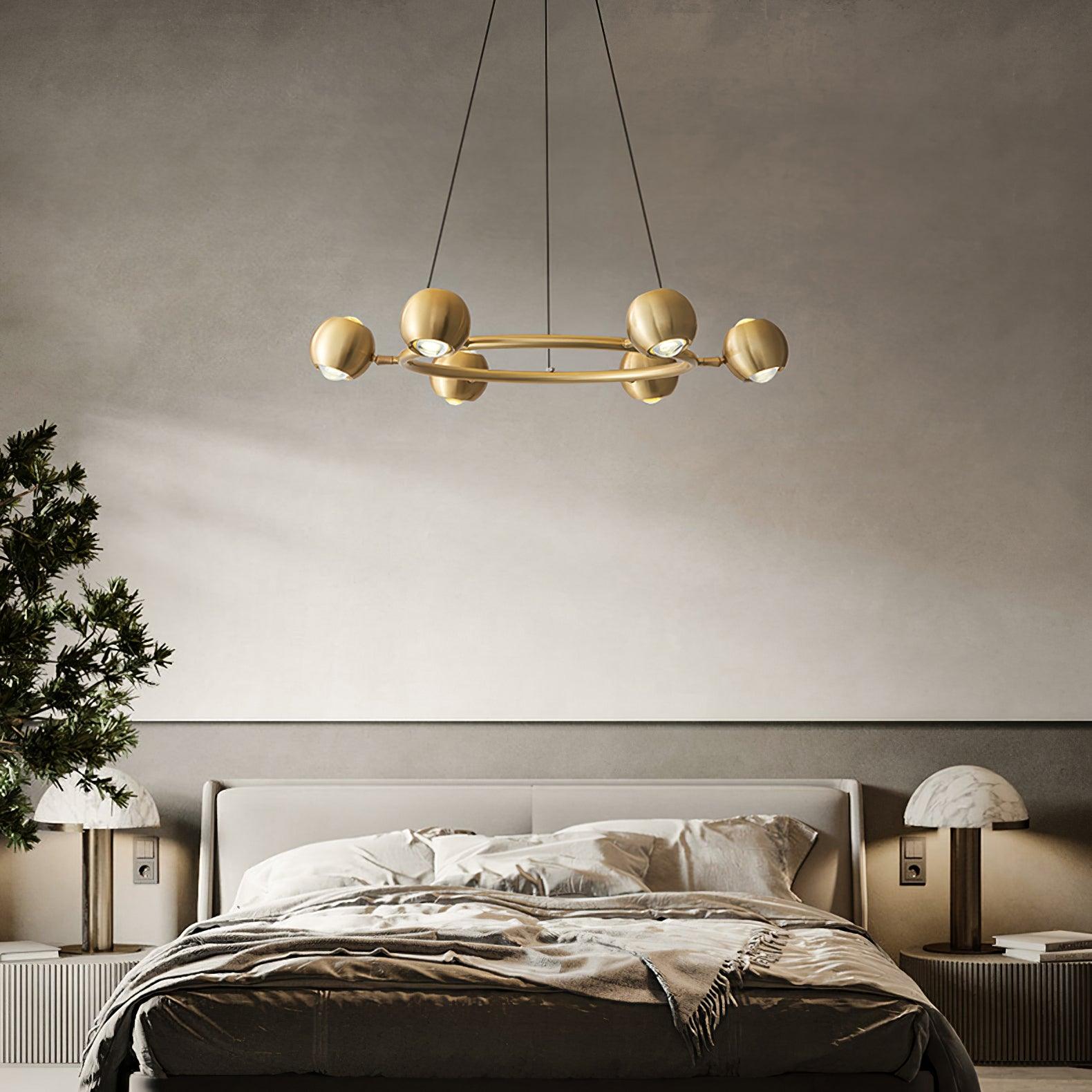 Six-head brass ring chandelier above a bed