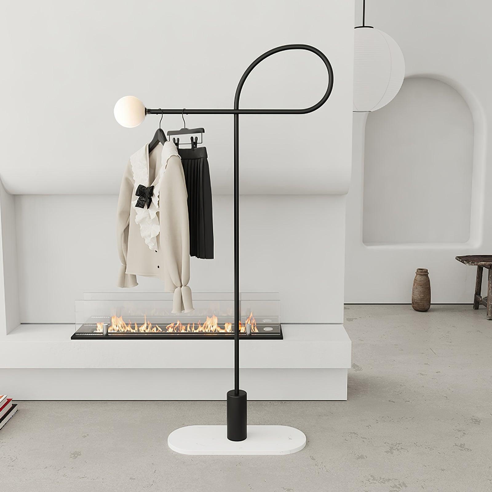 Arcane Orb pictured with garments on hangers along its arm and a white oval plate beneath the black base near a fireplace
