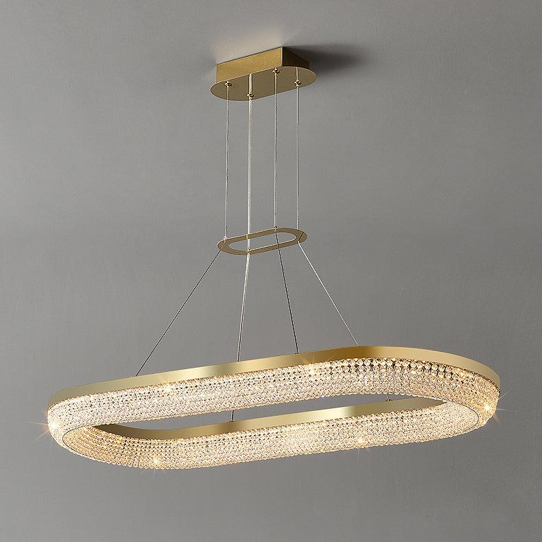 Complete elongated oval crystal chandelier with gold rim, elongated canopy and fine suspension cables