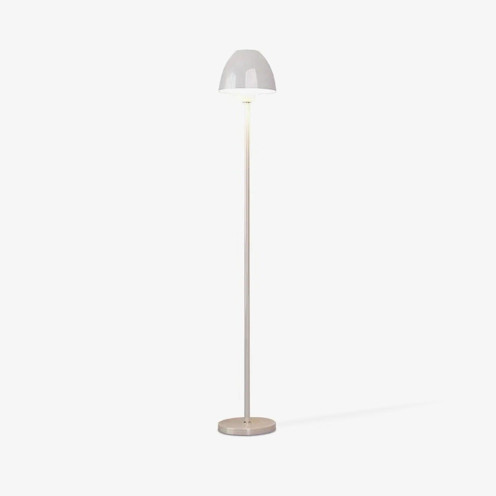 Full white floor lamp on a pale background, with a rounded shade and a faint shadow extending to the right