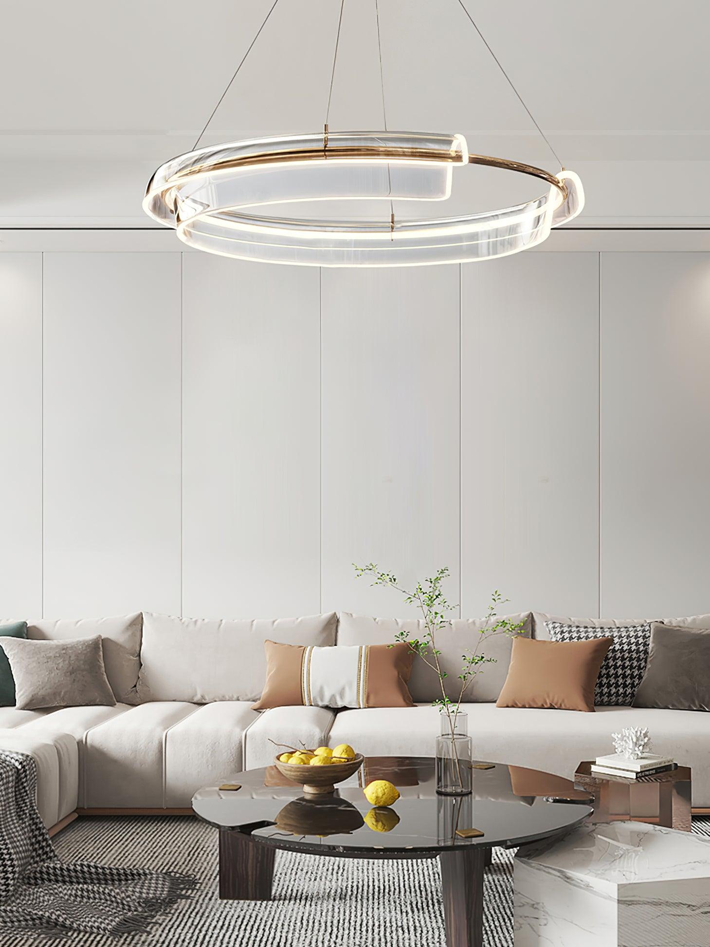 Circular chandelier above a white sectional sofa