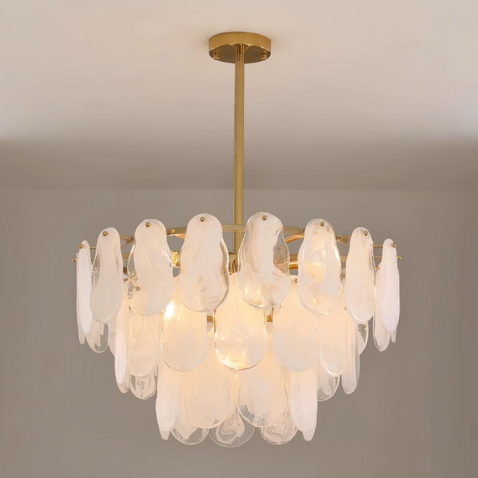Round Cloud glass pendant lit beneath a long central rod on a warm neutral background