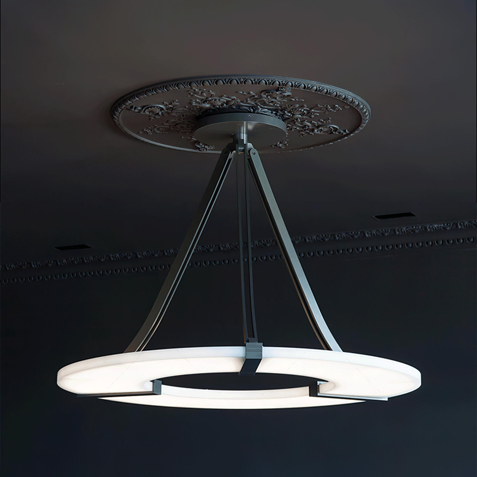 Side view of glowing halo pendant in dark room beneath floral ceiling medallion and cornice