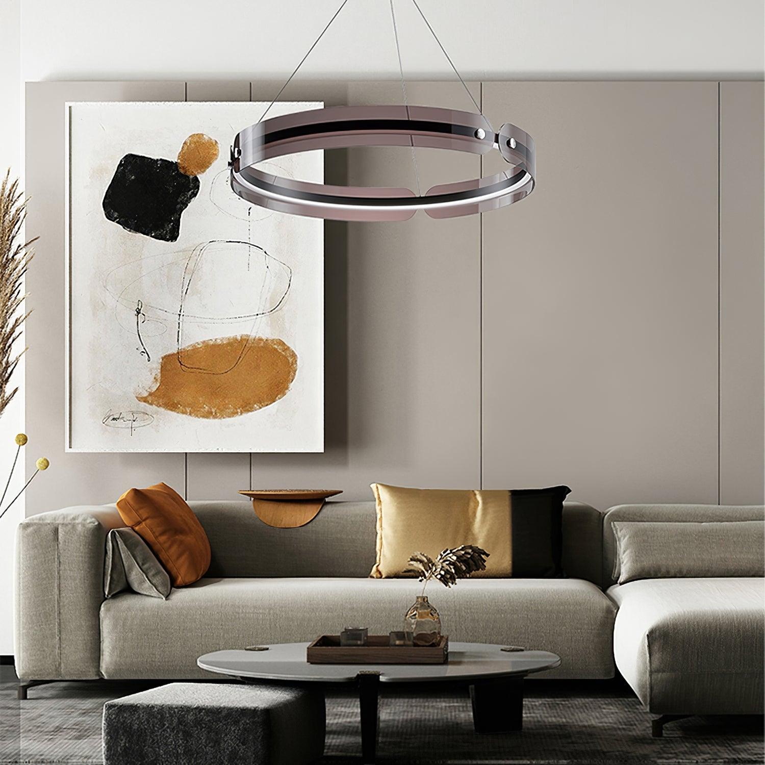 Javor illuminated coffee-tinted ring above a grey sofa with rust and gold cushions beneath abstract wall art