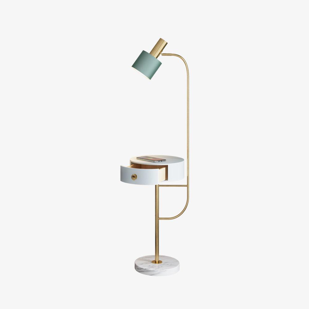 Full gold Agueda lamp on pale background, green shade, white open drawer table with phone and white veined circular base
