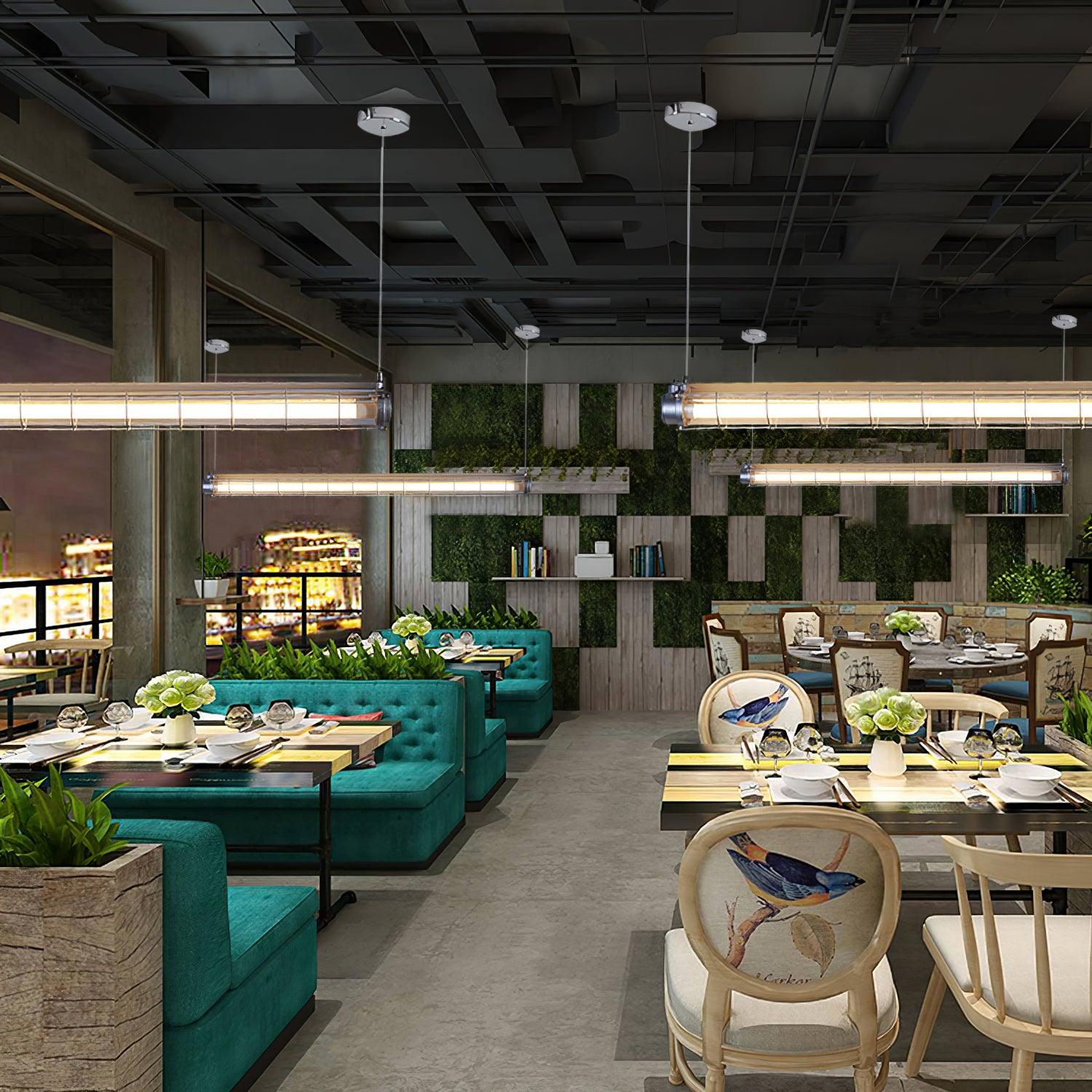Multiple Artisan Glass chandeliers arranged above restaurant tables and green upholstered seating