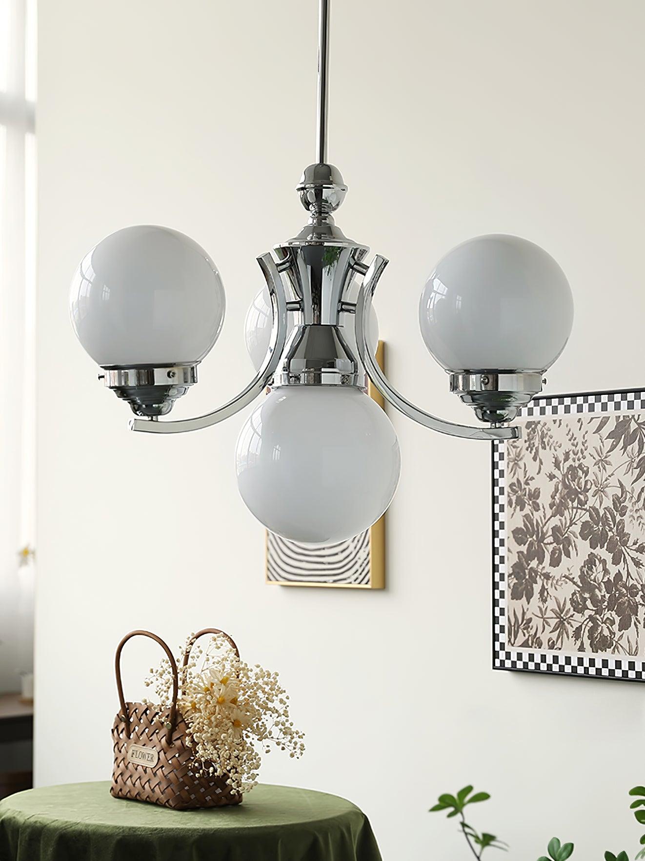 Close view of compact Dewdrop with white globes, curved chrome arms and a central lower globe above a flower basket