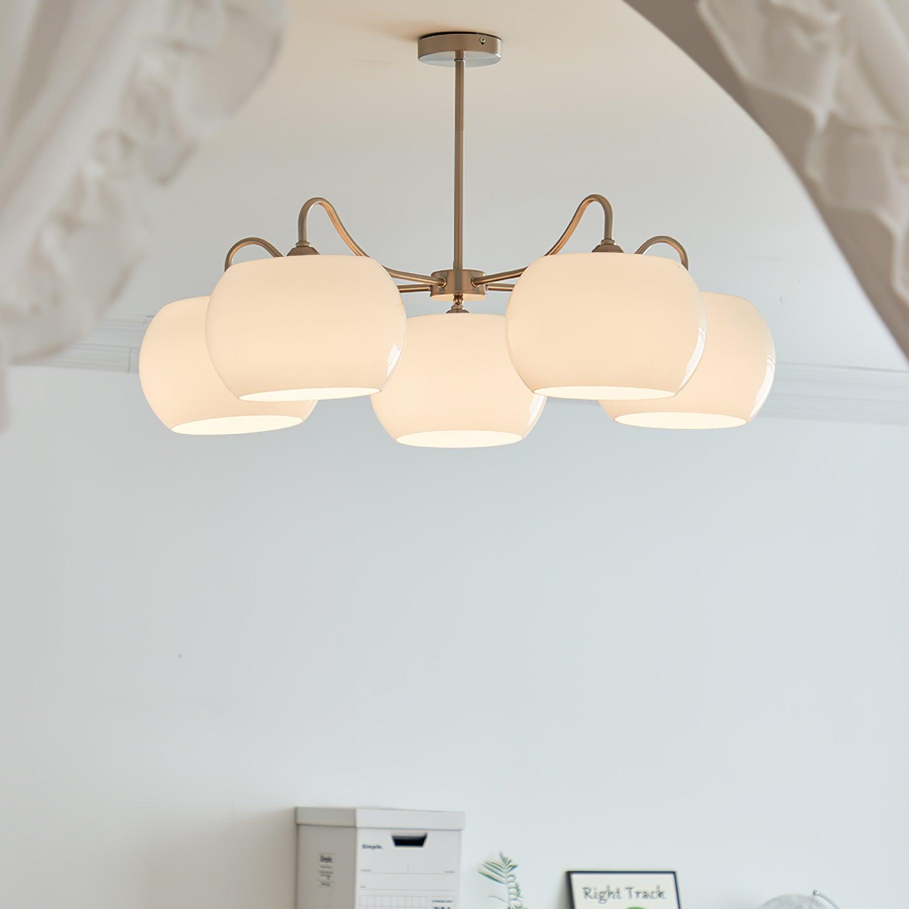 Persimmon chandelier with white glass shades and curved nickel-tone arms