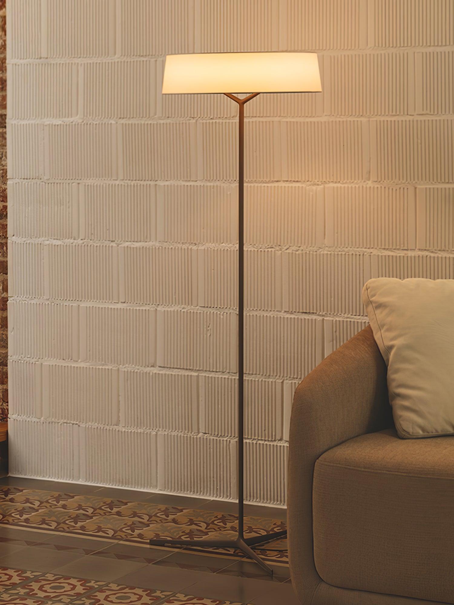 Warm-looking circular shade beside a sofa