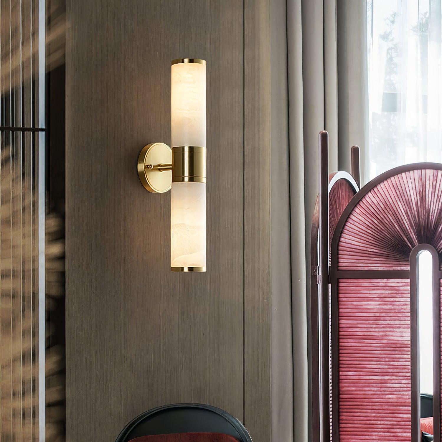 Tall alabaster wall light beside curtains and a red chair
