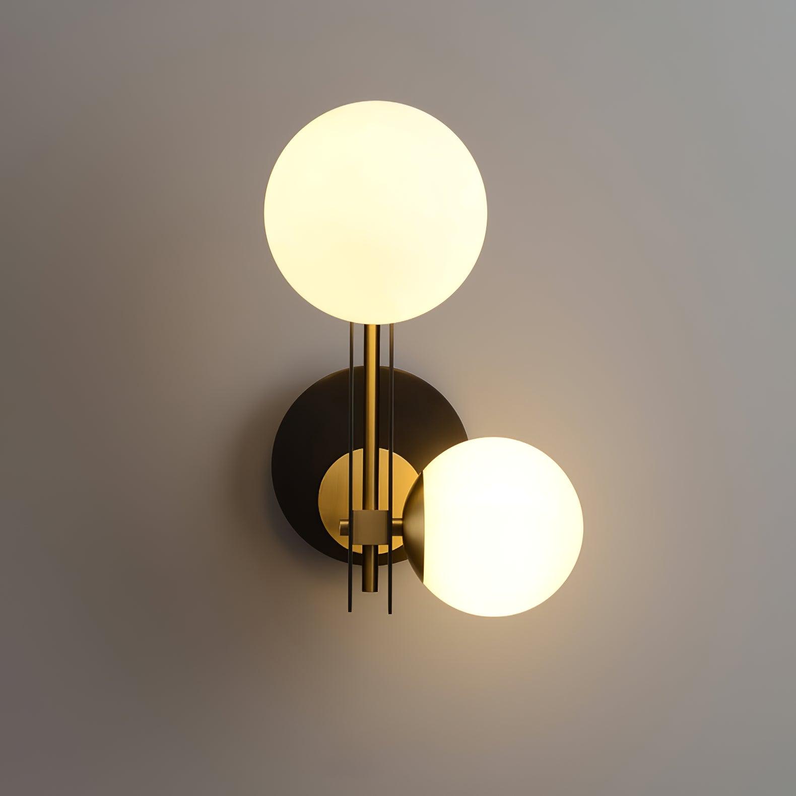 Front view of two glowing white globes, a brass-coloured centre rod and dark vertical rails