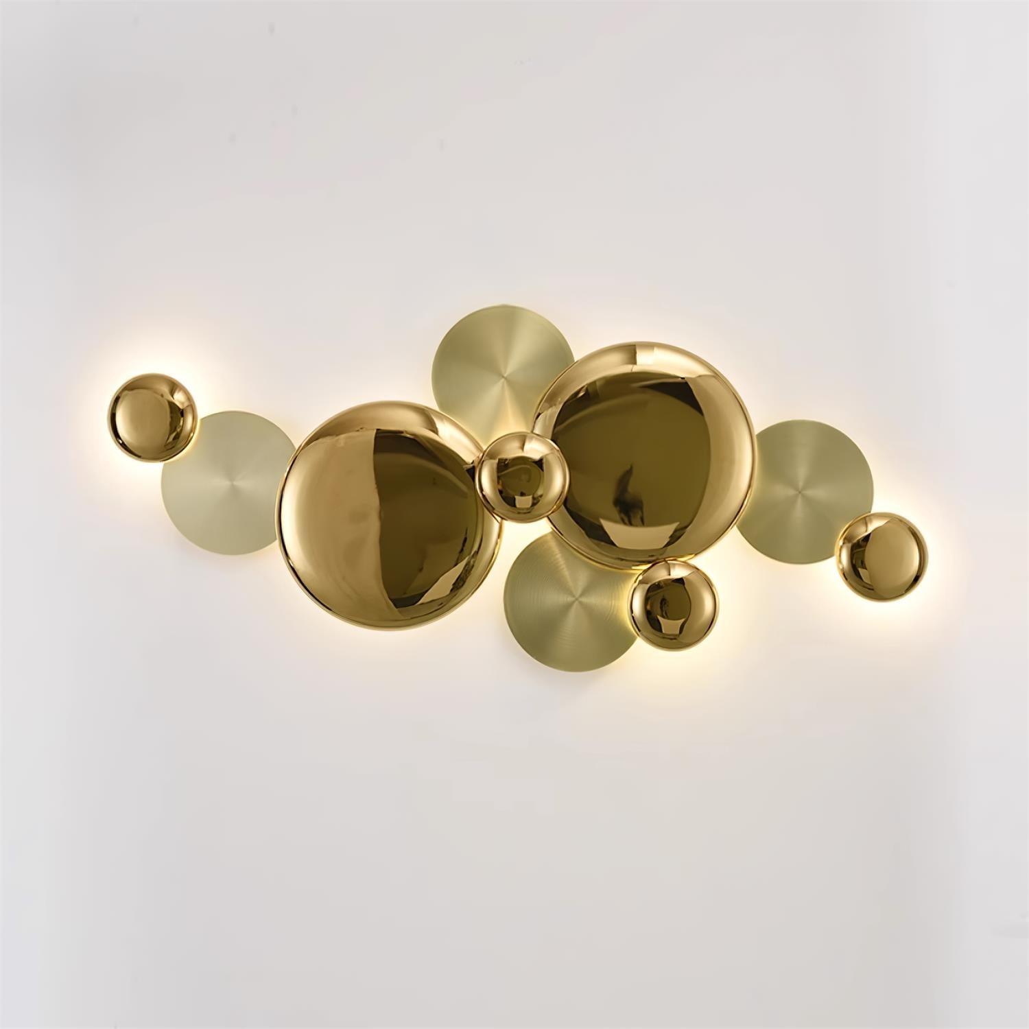 Illuminated Gold Pisco wall lamp with reflective circular faces overlapping flatter gold-tone discs
