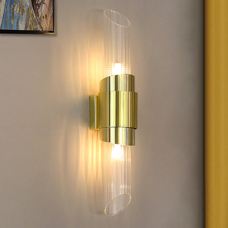Closer square crop of lit Gold ribbed crystal wall light beside yellow curtain and corner of abstract picture