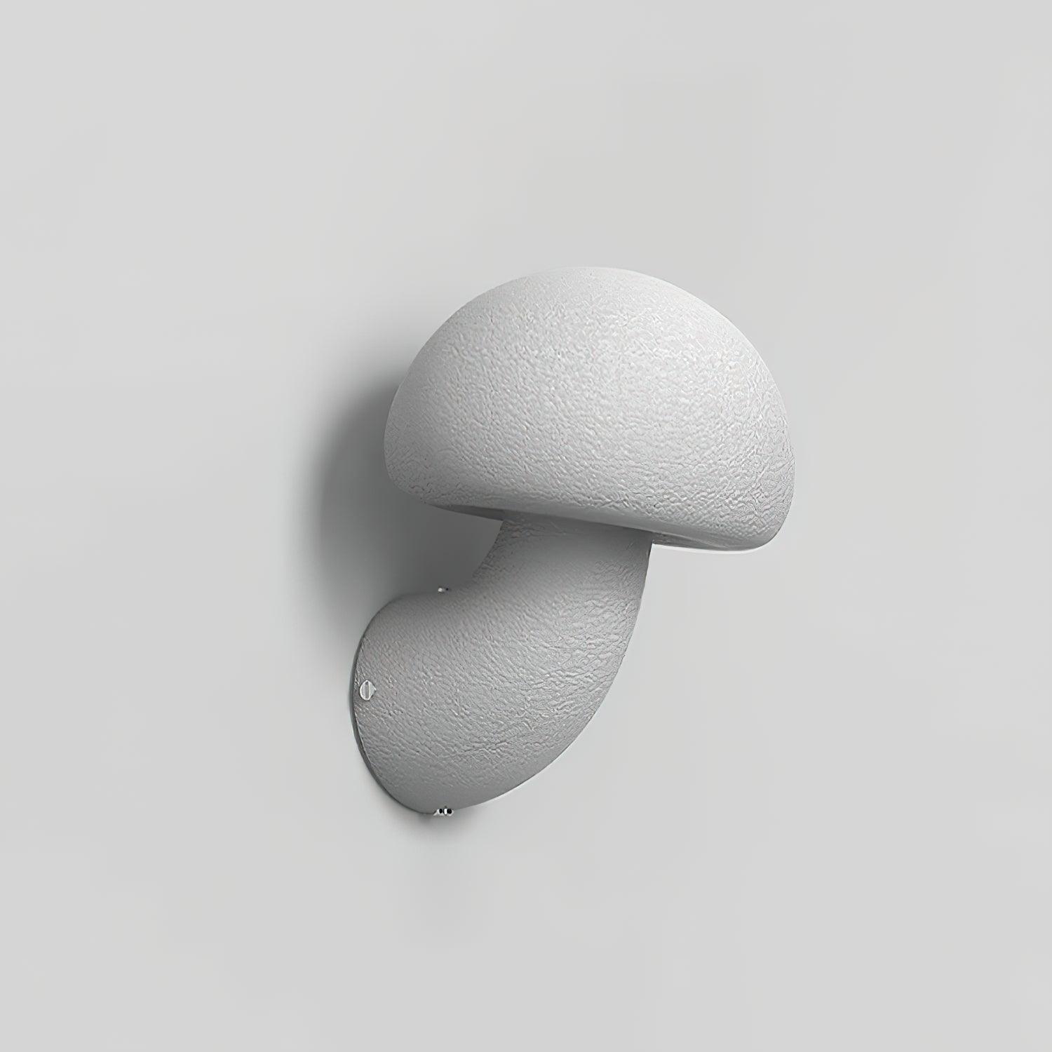 Unlit textured mushroom wall lamp against a pale background