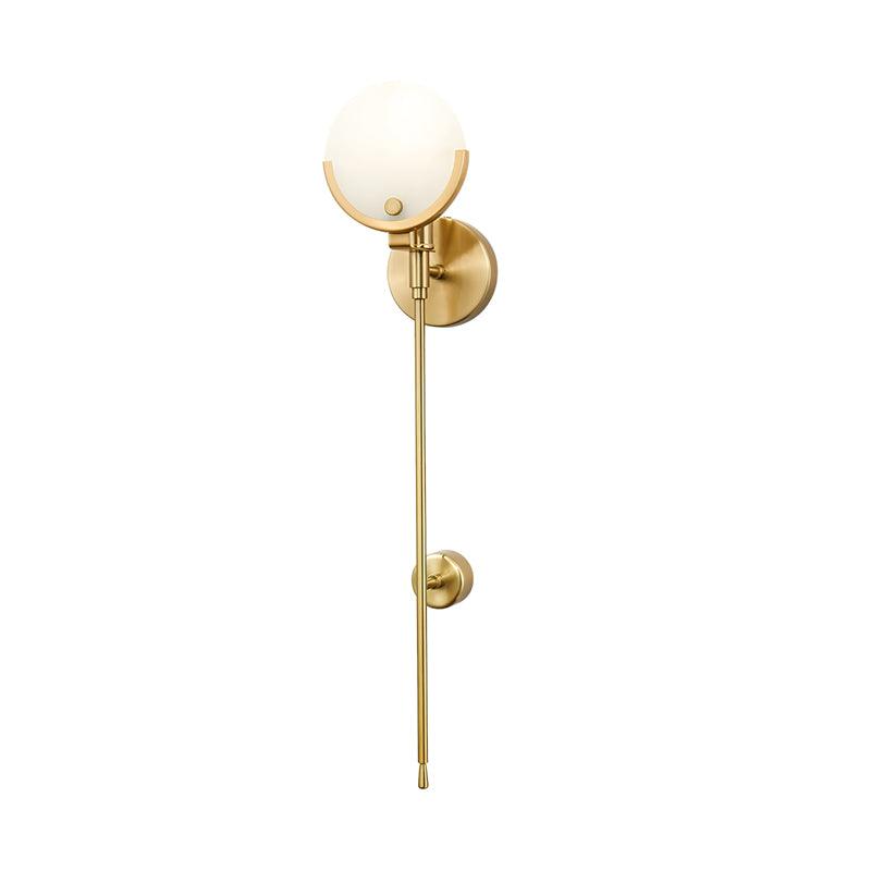 Isolated long-stem Ava design with a round pale shade and two brass wall plates, framed with wide margins