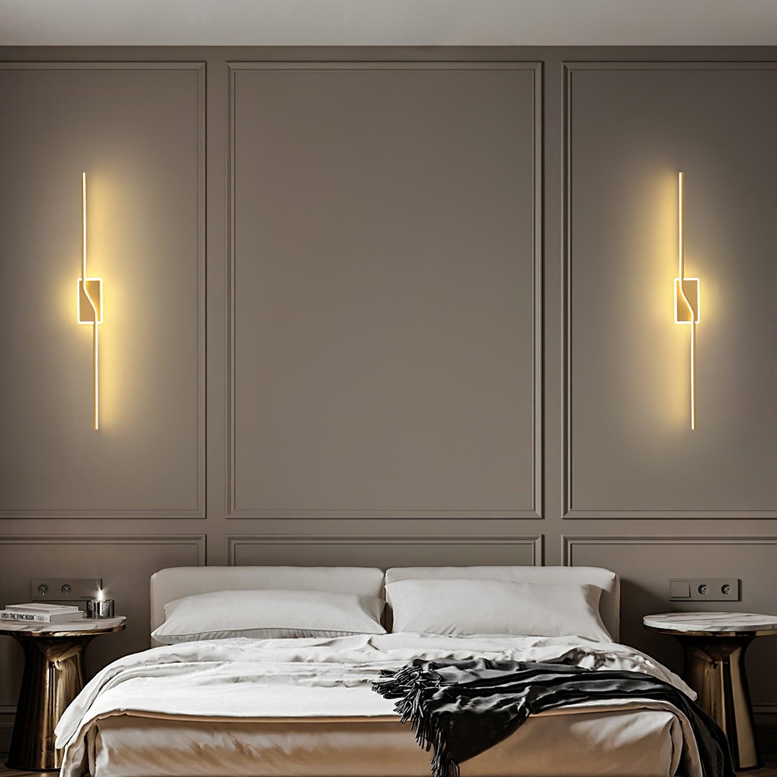 Two Gold linear wall lights above a bed