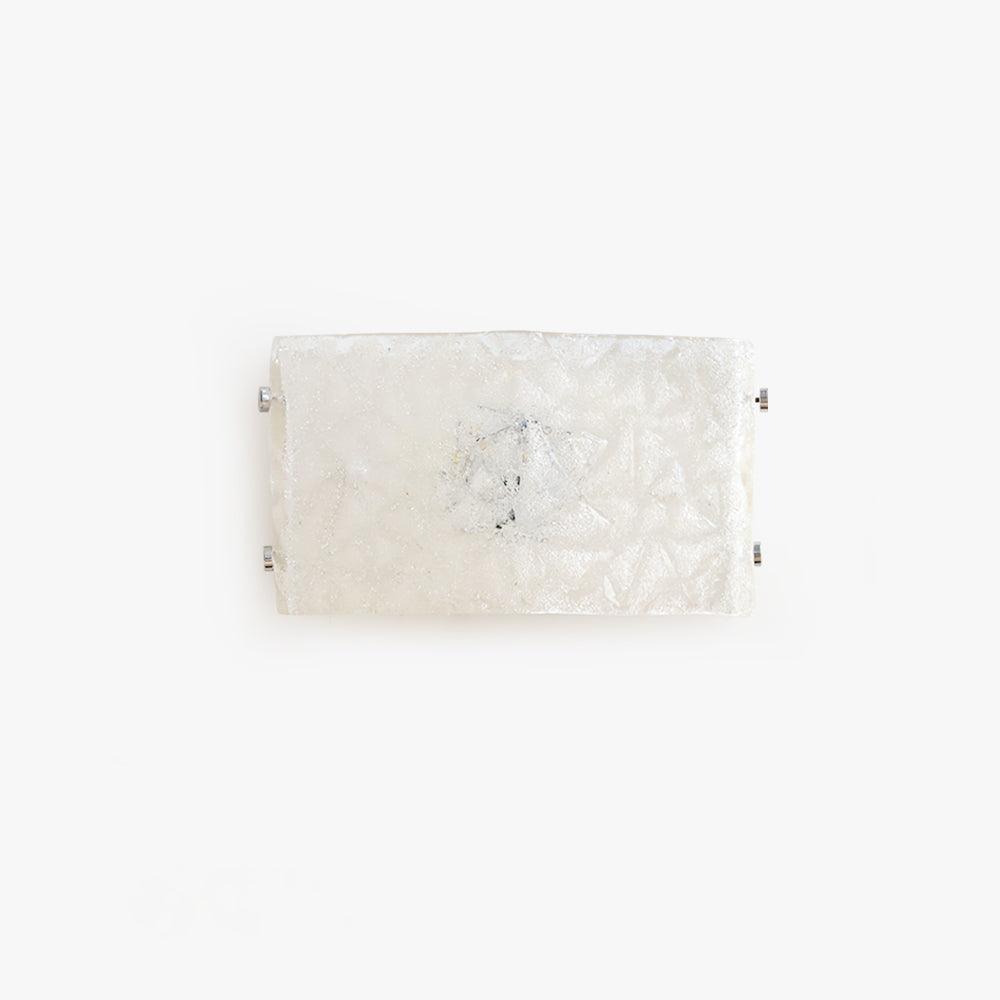 Isolated front view of unlit curved white textured glass wall light with four chrome edge fasteners on white