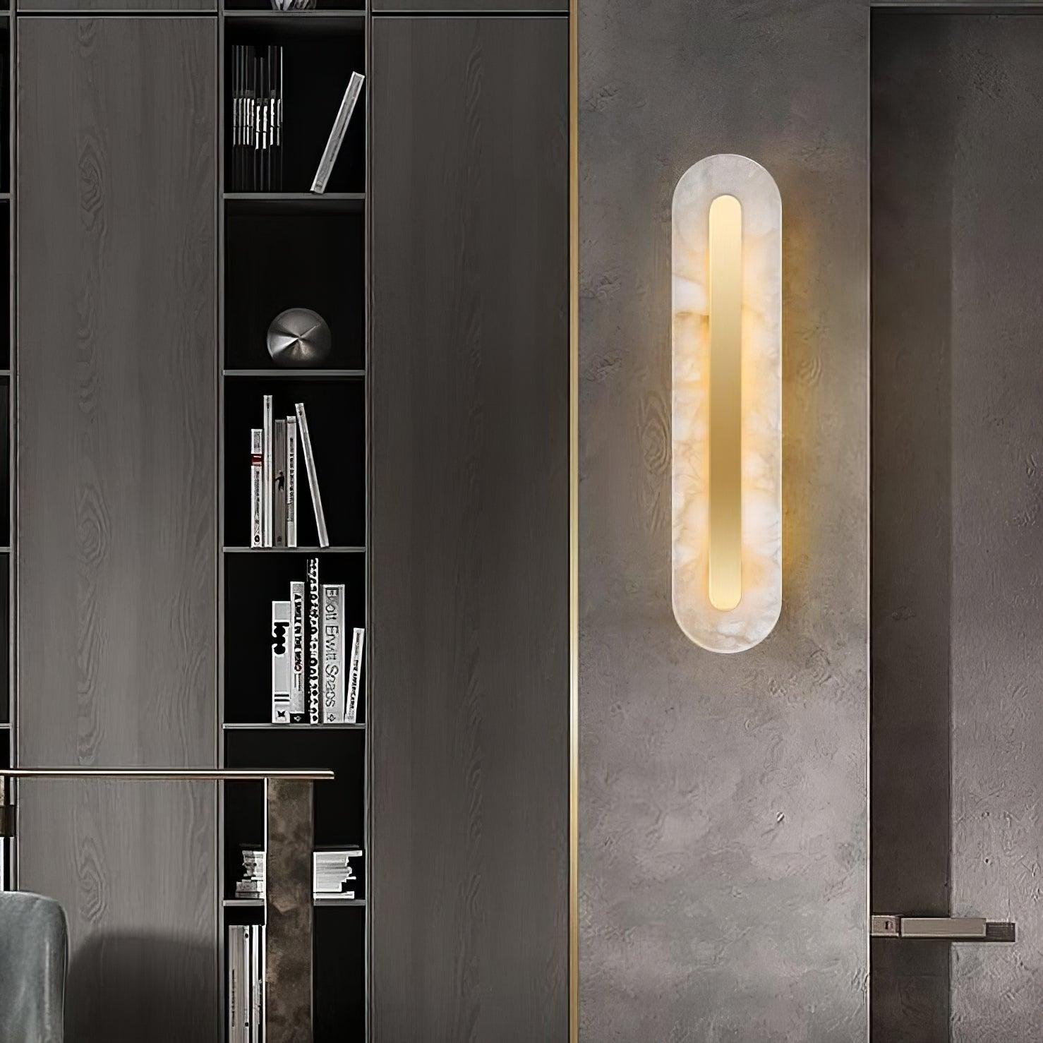 Alabaster wall light beside dark shelving
