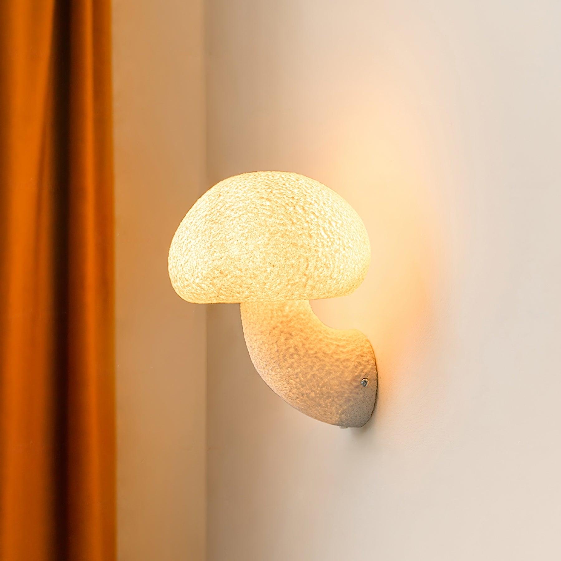 Lit mushroom wall light beside an orange curtain
