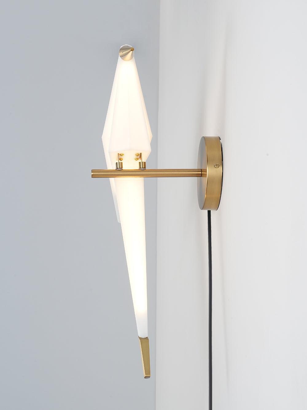 End view of the glowing White bird on a Gold wall arm, with two small attachments, round backplate edge and Black cable