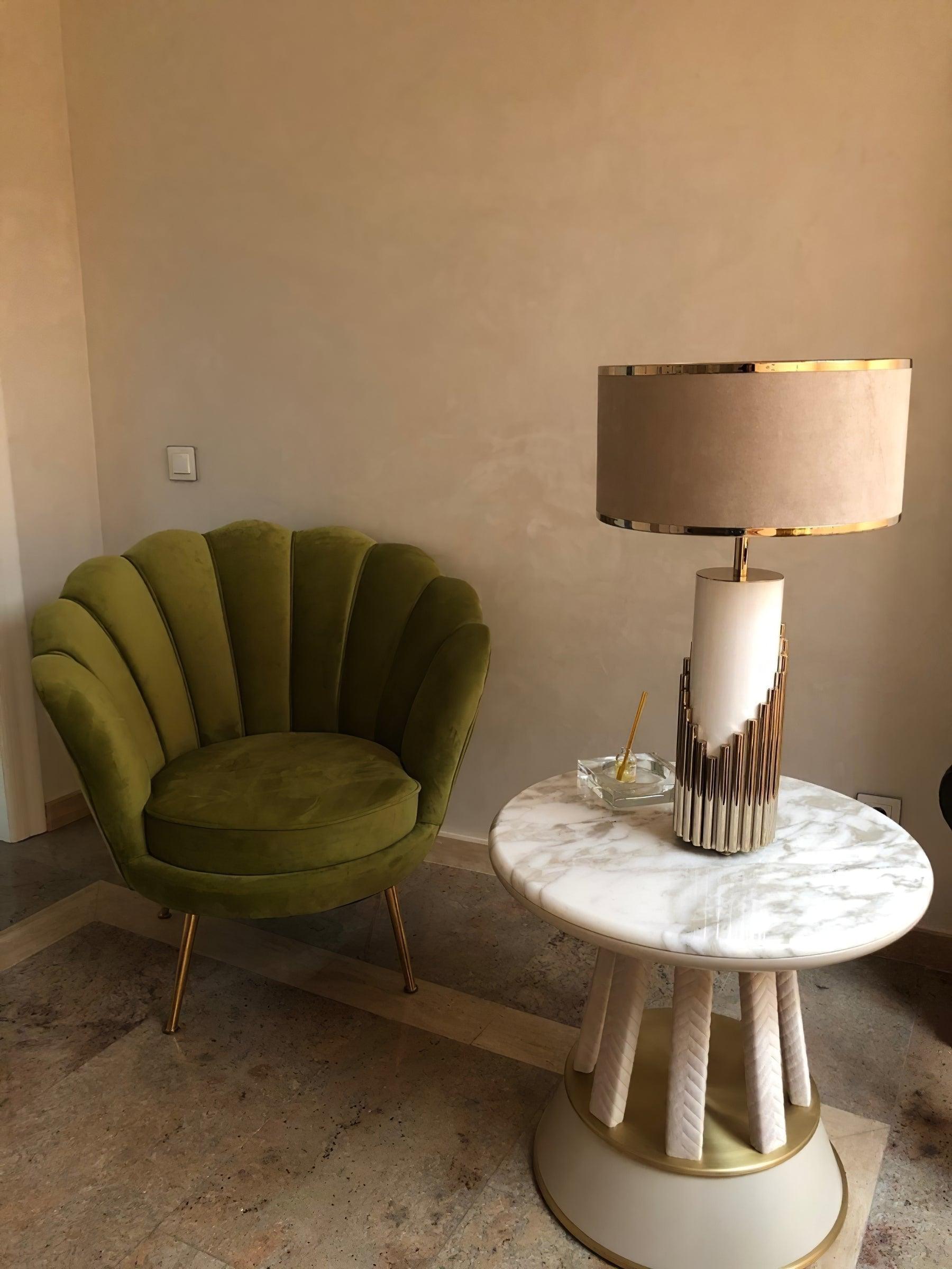 Streamline table lamp beside a green scalloped chair