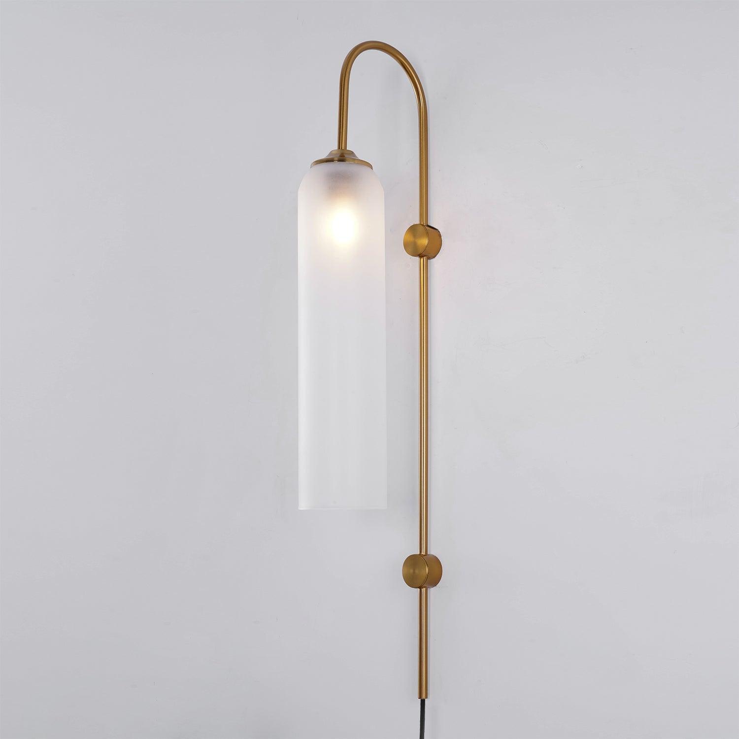 Frosted white cylindrical shade hanging from a gold-coloured curved wall arm