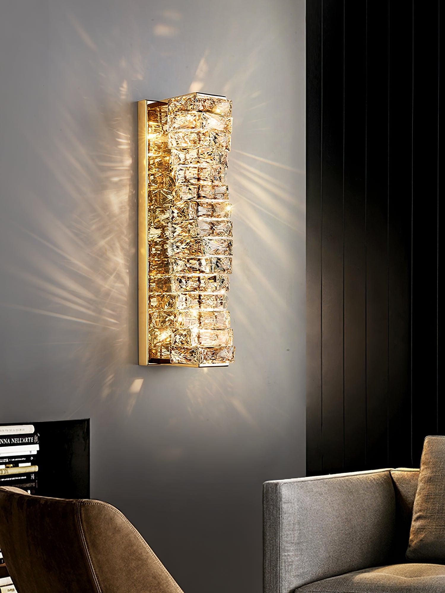 Gold crystal wall light above a lounge chair
