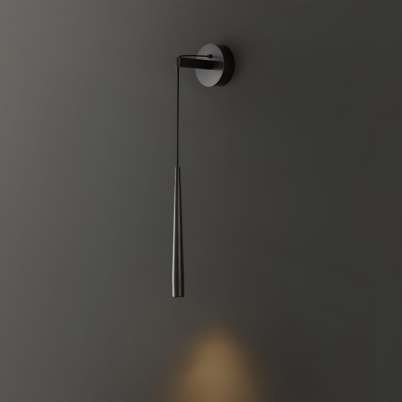 Plain-ended black tapered wall light casting a soft downward patch of light on dark grey