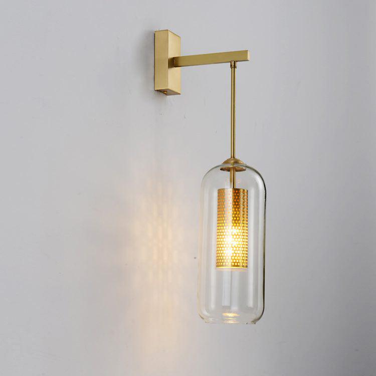 Copper-plated Vadim wall light with a clear capsule-shaped glass shade