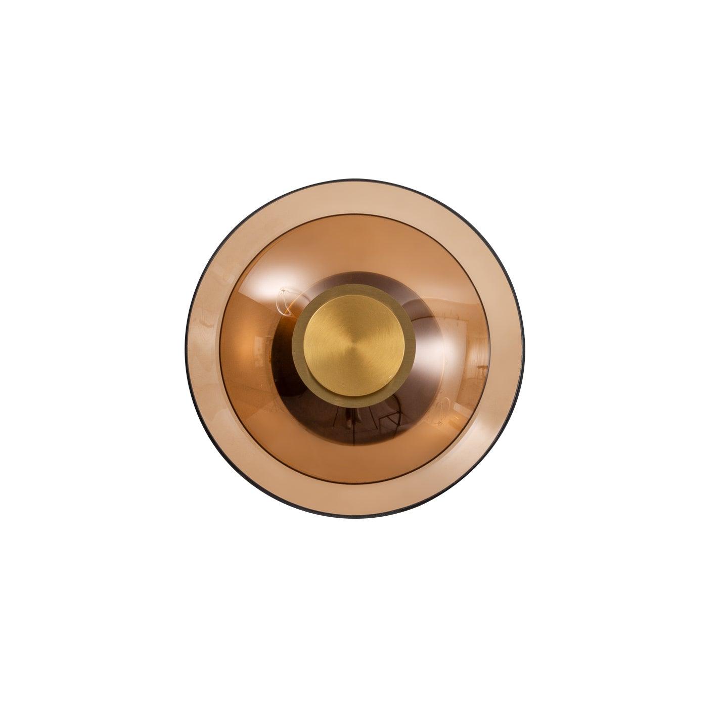 Gold and amber-toned glass disc sconce front view on white with wide margins, reflective smaller dome and round centre cap