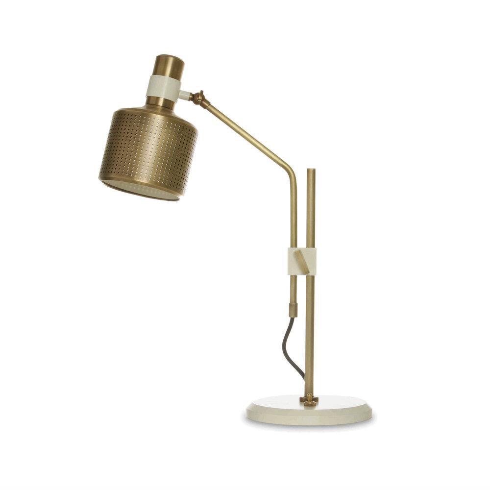 Isolated gold-and-white single-head lamp with a perforated shade, white collar and clamp, upright post and white round base