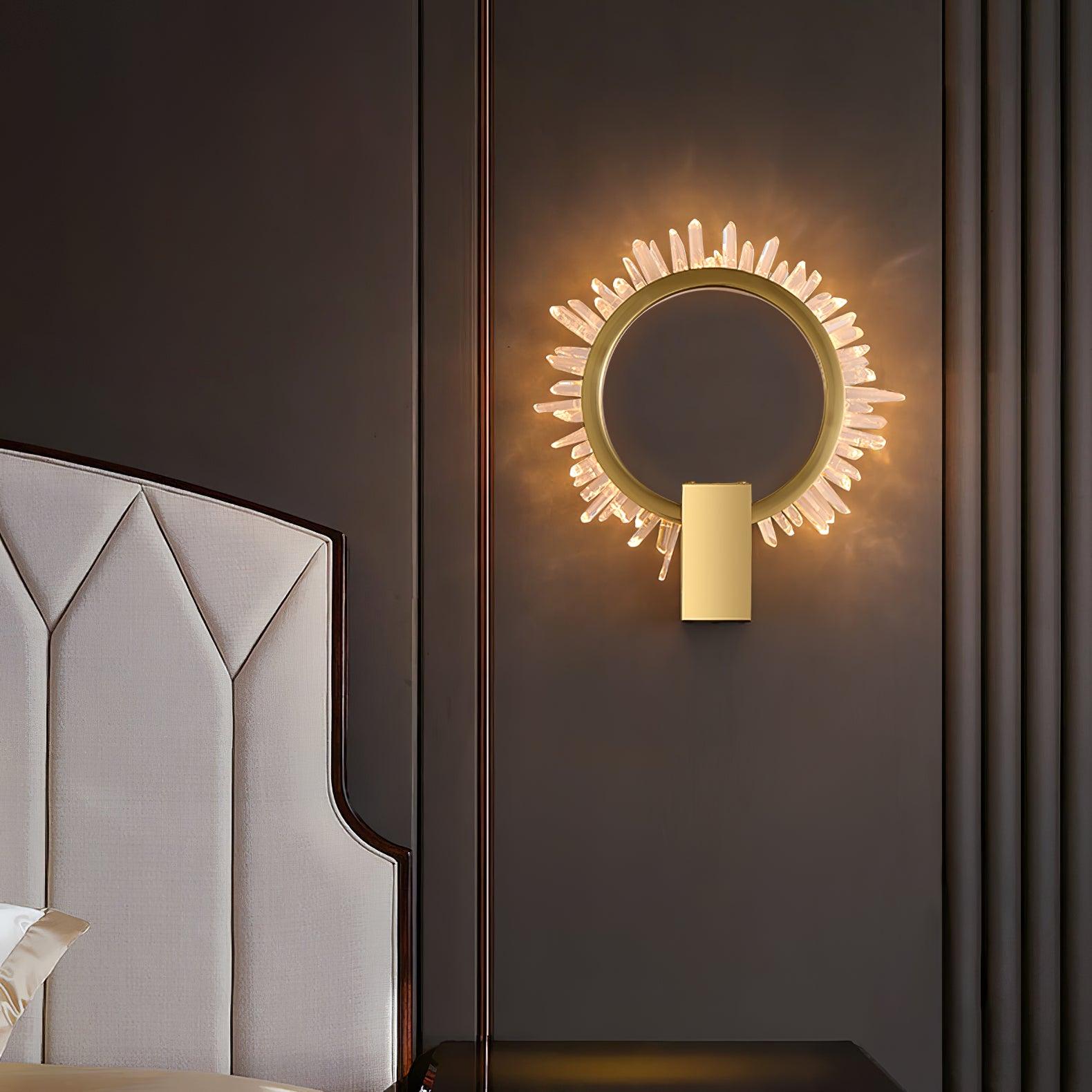 Front crystal ring wall light on brown panelling beside a pale geometric upholstered bedhead